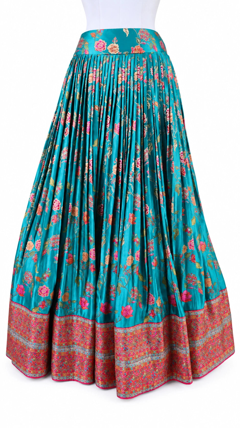 Turquoise florals, fresh green and bright pink bring a vivid contrast to this three-piece lehenga set by Vinisha Rao Designer Studio. The gathered Gaji silk lehenga features multicoloured floral motifs and a broad pink patterned border. The green raw silk blouse has a front button fastening, elbow-length sleeves and metallic floral embroidery around the neckline and cuffs. An open back with tassel ties completes the blouse, while the pink chiffon dupatta adds a soft layer with an embellished scalloped borde